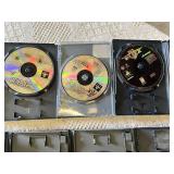 Multiple video games for PlayStation with titles such as Madden 99, Twisted Metal, and NBA Live 10.