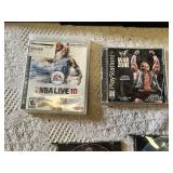 Multiple video games for PlayStation with titles such as Madden 99, Twisted Metal, and NBA Live 10.