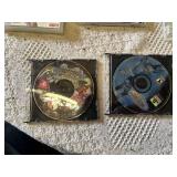 Multiple video games for PlayStation with titles such as Madden 99, Twisted Metal, and NBA Live 10.