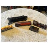 Model train set featuring locomotives and freight cars by Caterpillar and ATSF, plus tracks