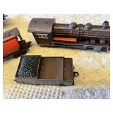 Model train set featuring locomotives and freight cars by Caterpillar and ATSF, plus tracks