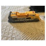 Model train set featuring locomotives and freight cars by Caterpillar and ATSF, plus tracks