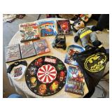 Superhero Collection including DVDs, Books, and Toys DVDs like Avengers: Age of Ultron and Superman Red Son, books such as Iron Man: The Gauntlet by Eoin Colfer, a Batman plush toy, a Marvel dartboard