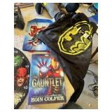Superhero Collection including DVDs, Books, and Toys DVDs like Avengers: Age of Ultron and Superman Red Son, books such as Iron Man: The Gauntlet by Eoin Colfer, a Batman plush toy, a Marvel dartboard