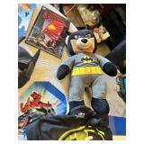 Superhero Collection including DVDs, Books, and Toys DVDs like Avengers: Age of Ultron and Superman Red Son, books such as Iron Man: The Gauntlet by Eoin Colfer, a Batman plush toy, a Marvel dartboard
