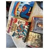 Superhero Collection including DVDs, Books, and Toys DVDs like Avengers: Age of Ultron and Superman Red Son, books such as Iron Man: The Gauntlet by Eoin Colfer, a Batman plush toy, a Marvel dartboard