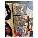 Superhero Collection including DVDs, Books, and Toys DVDs like Avengers: Age of Ultron and Superman Red Son, books such as Iron Man: The Gauntlet by Eoin Colfer, a Batman plush toy, a Marvel dartboard