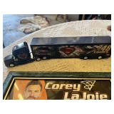 NASCAR Memorabilia Collection including Rusty Wallace Model Car, Corey LaJoie Autograph, NASCAR DVD, Monkey Plush, and Other Items