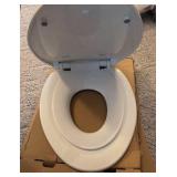 white elongated toilet seat with child seat insert and hardware