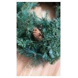 NearlyNature wreath with white lights and pine cones. Lights are battery powered with on/off/timer