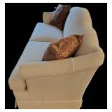 LR - Beige Upholstered Sofa With Throw Pillows