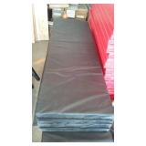 Black vinyl-covered gymnasium safety wall padding with foam core.
