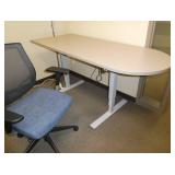 Adjustable height table with rounded end and office chair