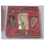 Set of Brass Holiday Decorations including Candle Holders, Musical Instrument Ornaments, and Pineapple Wall Art