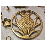 Set of Brass Holiday Decorations including Candle Holders, Musical Instrument Ornaments, and Pineapple Wall Art