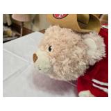 Assorted NFL Memorabilia including Armchair Quarterback Board Game (uncounted), 49ers Plush Toy, and Various Collectible Figurines