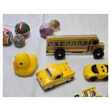 Yellow toy vehicle and accessory set including Parker Store Miniature Race Car, Burger King Crayola Crayon Box, and Assorted Toy Balls