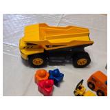 Toy Construction Vehicles and Accessories Lot including CAT Dump Truck, Orange Rescue Vehicle, and Big Bulldozer Book