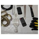 Assorted Kitchen and Household Items including Kitchen Tools, Extension Cords, and Gloves