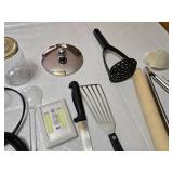 Assorted Kitchen and Household Items including Kitchen Tools, Extension Cords, and Gloves