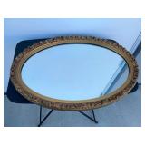 Oval mirror with gold frame