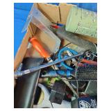 This box contains a mix of miscellaneous garage items, hand tools, small electronics, and personal care products.