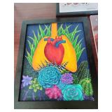 The framed art on the left features a stylized human heart surrounded by colorful succulent plants.
