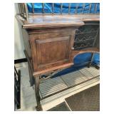 This French country-style bar console features a rich wood top and a decorative wrought iron frame
