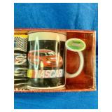2005 NASCAR "Flat-Out" Mug Set featuring colorful stock car graphics and includes two coffee mugs.
