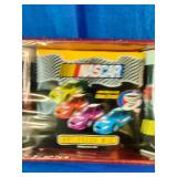 2005 NASCAR "Flat-Out" Mug Set featuring colorful stock car graphics and includes two coffee mugs.