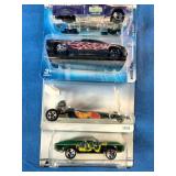 Stack of six carded Hot Wheels die-cast cars packaged from the late 1990s through the mid-2000s.