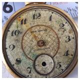 New Haven compensated pocket watch features a weathered geometric face and a gold-tone case