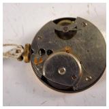 New Haven compensated pocket watch features a weathered geometric face and a gold-tone case