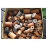box of wooden spools