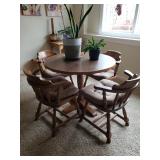 Round Oak table with 4 wood chairs that have pads on. Asking $110.00