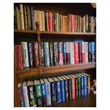 Library full of Tom Clancys Novels Hard Covers