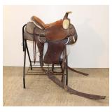  Lot 595 Donnie Haney 16" western leather saddle, brown, with stand and blanket