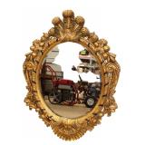  Lot 617 Heavily carved bevel glass composition decorator mirror