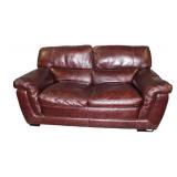  Lot 673 Brown leather 2 cushion loveseat, does have wear