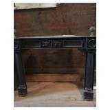 iron mantle with decorated doors