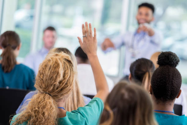 Woman asking a question at a conference