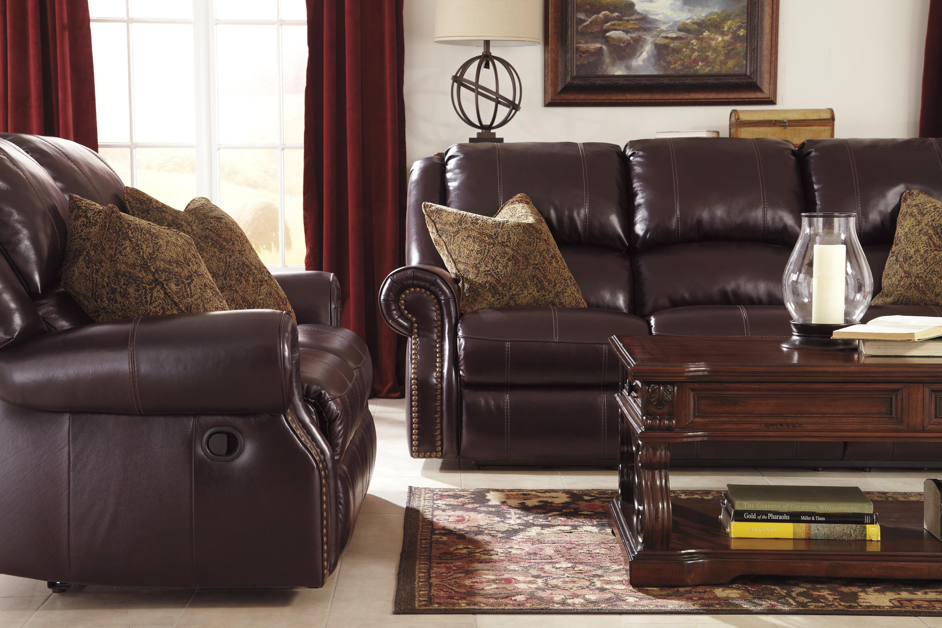 Leather Match Reclining Sofa with Nailhead Trim by Signature