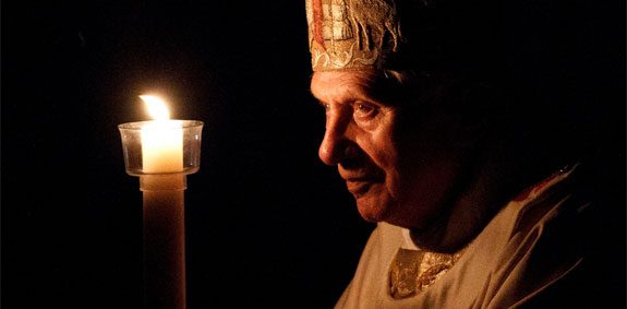 1272benxvieaste_00000000795 Pope Benedict XVI carries a candle in procession as he arrives to celebrate the Easter Vigil Mass in St. Peter's Basilica at the Vatican April 7. (CNS photo/Paul Haring)
