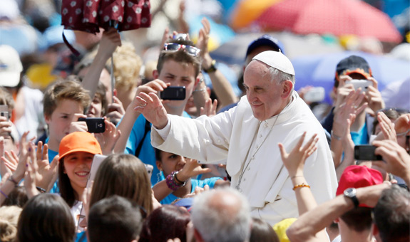 Pope Francis greets the crowd after celebrating a Mass at which he confirmed 44 people in St. Peter's Square at the Vatican April 28. (CNS photo/Paul Haring)