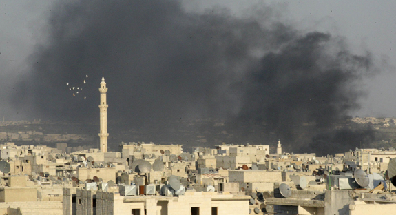 Smoke rises amid buildings in Syria