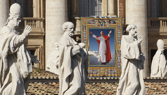 Tapestry of Blessed Paul VI hangs from facade of St. Peter's Basilica during his beatification Mass at Vatican