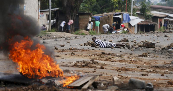Demonstrators take cover during protest against Burundi President Pierre Nkurunziza