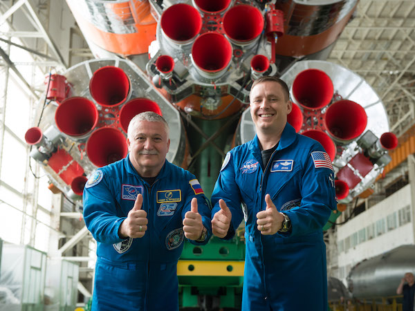 jsc2017e043850 (April 14, 2017) --- In the Integration Facility at the Baikonur Cosmodrome in Kazakhstan, Expedition 51 crewmembers Fyodor Yurchikhin of the Russian Federal Space Agency (Roscosmos, left) and Jack Fischer of NASA (right) provide a “thumbs up” as they pose for pictures April 14 in front of their Soyuz booster rocket. Fischer and Yurchikhin will launch April 20 on the Soyuz MS-04 spacecraft for a four and a half month mission on the International Space Station. Credit: NASA/Gagarin Cosmonaut Training Center/Andrey Shelepin