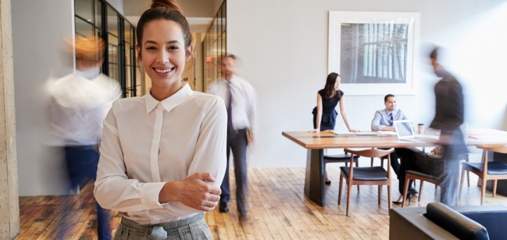 Portrait,Of,Young,White,Woman,In,A,Busy,Modern,Workplace