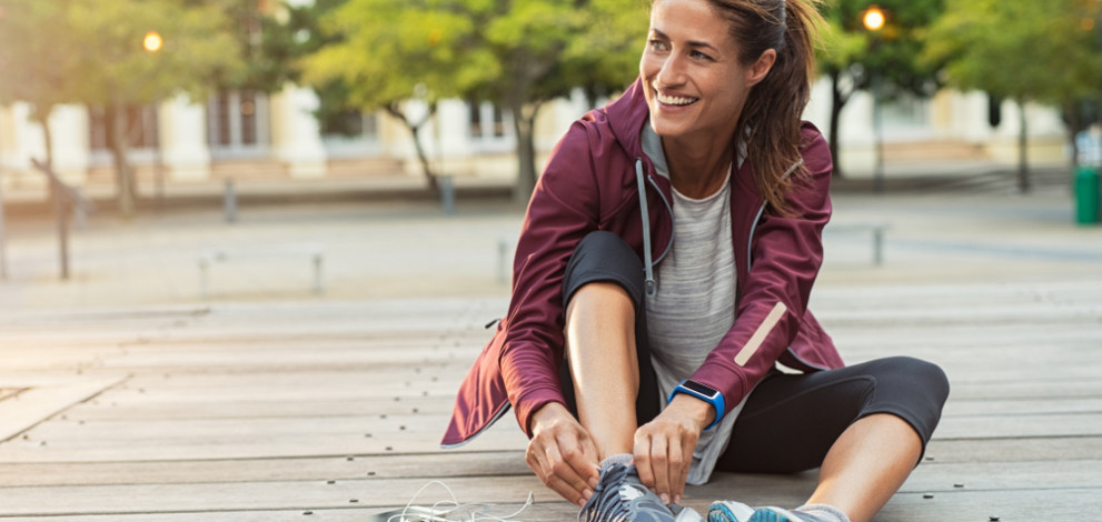 Mature,Fitness,Woman,Tie,Shoelaces,On,Road.,Cheerful,Runner,Sitting